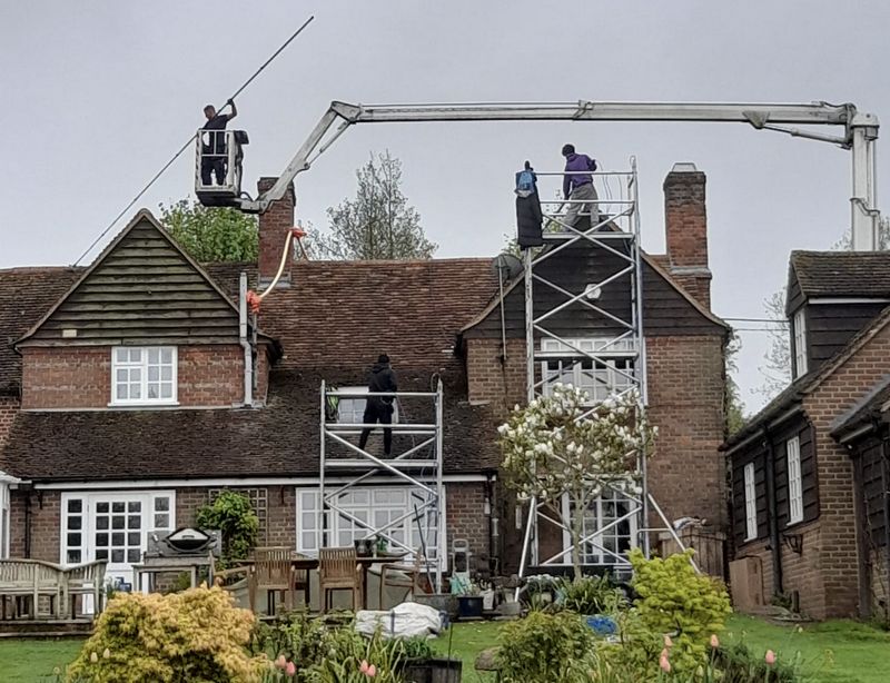 The Moss Cleaners using cherry picker and scaffolding to clean roof safely and professionally in Hamble-le-Rice, Hampshire